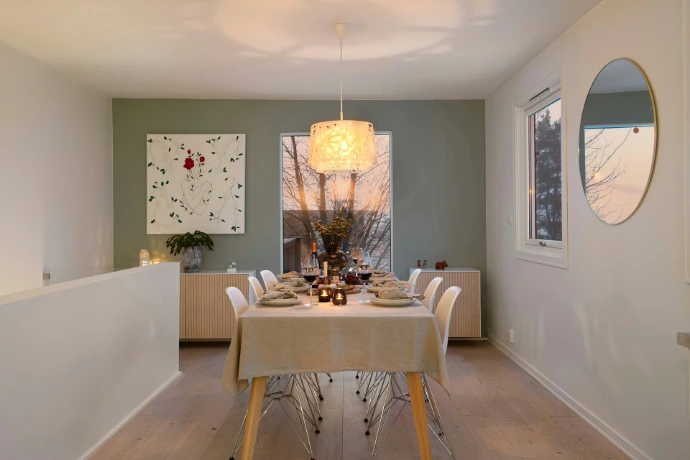 A dining room with a table and chairs